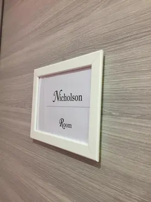 a picture frame on a wall with the name of a room at Oscar 2 in Rome