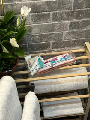 a towel rack with towels and toothbrushes at Candia Rooms in Rome