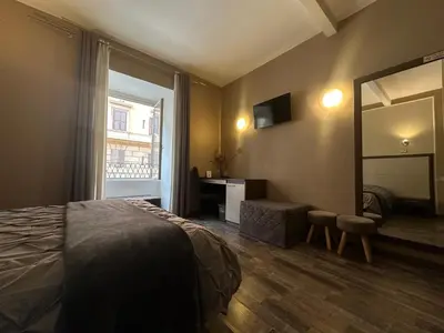 a hotel room with a bed and a mirror at Candia Rooms in Rome