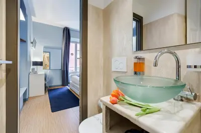 a bathroom with a bowl sink in a room at Easy Budget Colosseo in Rome