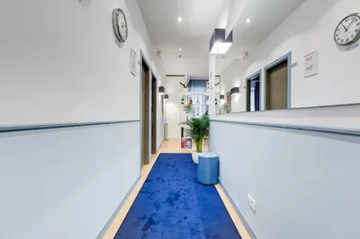 a hallway with a blue carpet in a room at Easy Budget Colosseo in Rome