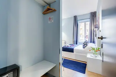 a small bedroom with a bed and a window at Easy Budget Colosseo in Rome
