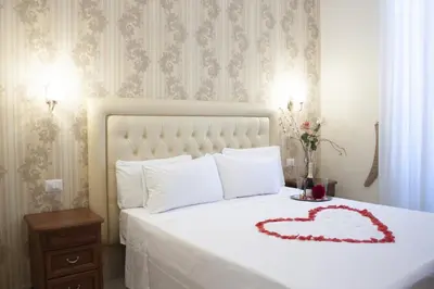 a bedroom with a bed with a heart on it at Suite Dal Conte in Rome