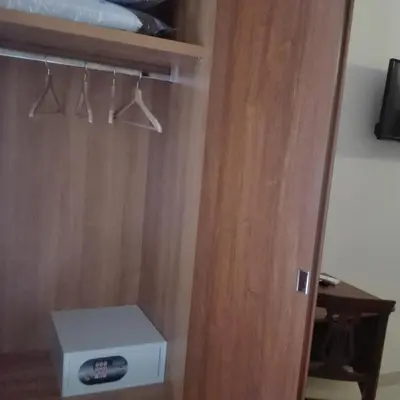 a closet with a wooden door and a box at Suite Dal Conte in Rome
