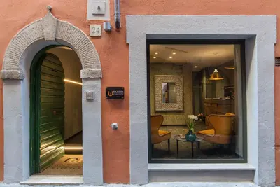 an entrance to a building with a table and chairs at Navona Essence Hotel in Rome