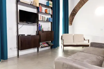 a living room with a tv on a book shelf at Trastevere Casa Renella 92 in Rome
