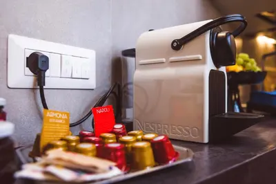 a toaster on a counter next to a plate of food at Trastevere Casa Renella 92 in Rome