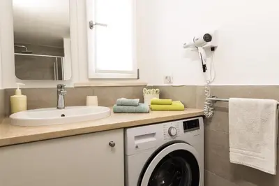 a bathroom with a washing machine and a sink at Trastevere Casa Renella 92 in Rome