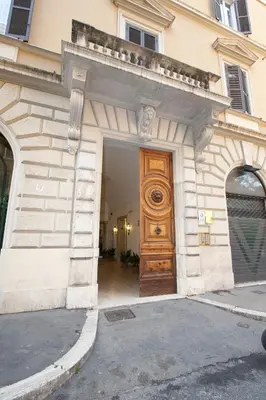 a large wooden door on the side of a building at Aelius in Rome