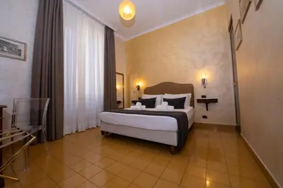 a bedroom with a large bed in a room at Aelius in Rome