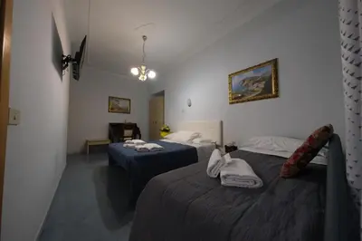 a bedroom with a bed with a red comforter at Andromeda by Gialel in Rome