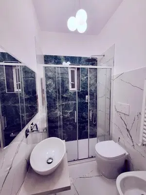 a white bathroom with a toilet and a sink at Rhome Sweet Rhome in Rome