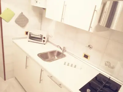 a white kitchen with a sink and a microwave at Rhome Sweet Rhome in Rome
