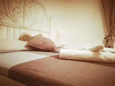 a bed with two pillows on it in a bedroom at Rhome Sweet Rhome in Rome