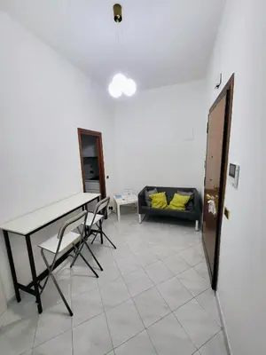 a living room with a table and a couch at Rhome Sweet Rhome in Rome