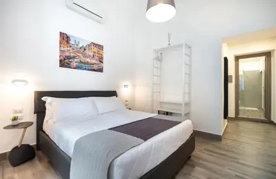a bedroom with a bed and a ladder in it at Clementi 18 Suites Rome in Rome