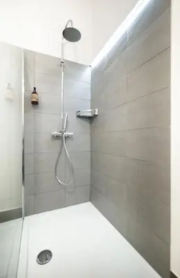 a shower with a glass door in a bathroom at Clementi 18 Suites Rome in Rome