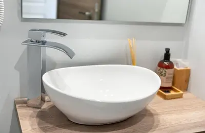 a white bowl sink on a counter in a bathroom at Clementi 18 Suites Rome in Rome