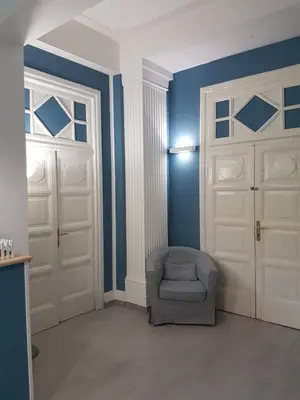 a room with two white doors and a chair at La Locanda dell'Angelo in Rome