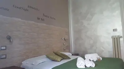 a bedroom with two beds with towels on them at La Locanda dell'Angelo in Rome
