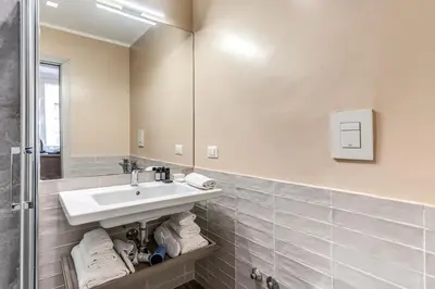 a bathroom with a sink and a mirror at Reginella Suites in Rome