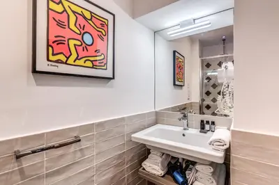 a bathroom with a sink and a mirror at Reginella Suites in Rome