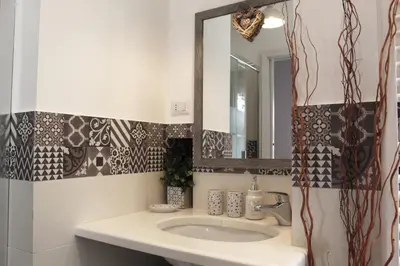 a bathroom with a sink and a mirror at Terrazza 29 Holiday Home in Rome