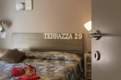 a hotel room with a bed and a sign on the wall at Terrazza 29 Holiday Home in Rome