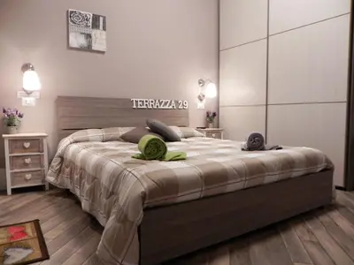 a bedroom with a bed with two green towels on it at Terrazza 29 Holiday Home in Rome