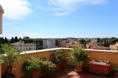 a balcony with potted plants and a view of a city at Terrazza 29 Holiday Home in Rome
