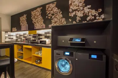 a washer and dryer in a laundry room at MEININGER Roma Termini in Rome