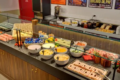 a buffet line with many different types of food at MEININGER Roma Termini in Rome