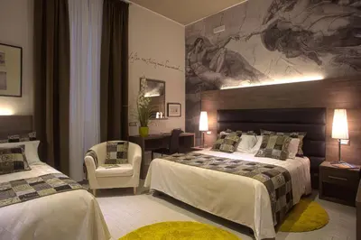 a hotel room with two beds and a painting on the wall at Hotel Marcantonio in Rome