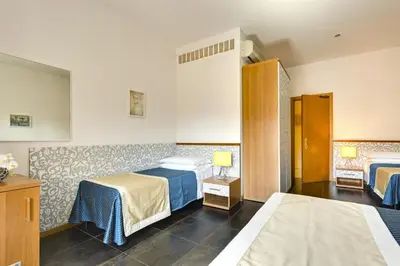 a hotel room with two beds in a room at Hotel Marcantonio in Rome