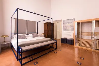 a bedroom with a canopy bed in a room at Experience Collection by ROMAC - Costaguti Experience in Rome