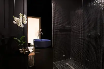 a bathroom with a blue sink and a shower at Experience Collection by ROMAC - Costaguti Experience in Rome