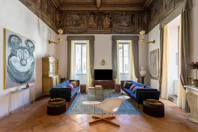 a living room with blue couches and a table at Experience Collection by ROMAC - Costaguti Experience in Rome
