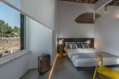a bedroom with a large bed and a window at First Floor - Boutique Hotel in Rome