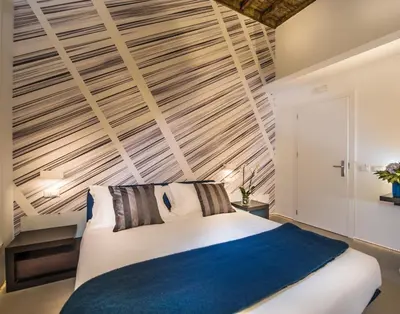 a bedroom with a bed and a wooden ceiling at First Floor - Boutique Hotel in Rome