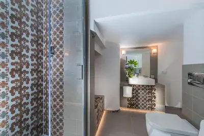 a bathroom with a shower and a toilet and a sink at First Floor - Boutique Hotel in Rome