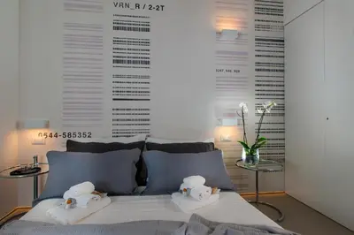 a bedroom with a bed with two towels on it at First Floor - Boutique Hotel in Rome