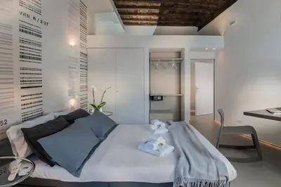 a bedroom with a large bed and a desk at First Floor - Boutique Hotel in Rome