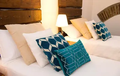 a group of pillows sitting on a bed in a room at DormiRoma - Cedro 21 Apartments in Rome