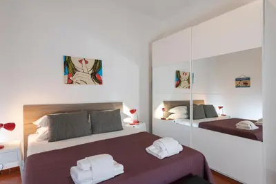 a bedroom with two beds and a mirror at Opera House in Rome