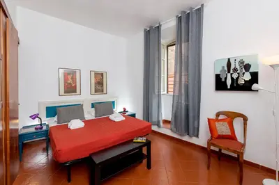 a room with a red table and a chair at Opera House in Rome