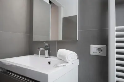 a bathroom with a white sink and a mirror at Opera House in Rome