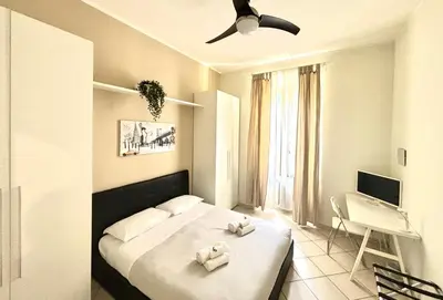 a bedroom with a bed with two towels on it at Enjoy Ponte Lungo in Rome