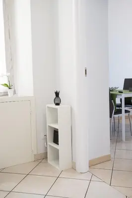 a room with white walls and a white cabinet at Enjoy Ponte Lungo in Rome