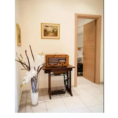 a room with a table with a radio on it at Domus Ines Roma San pietro in Rome
