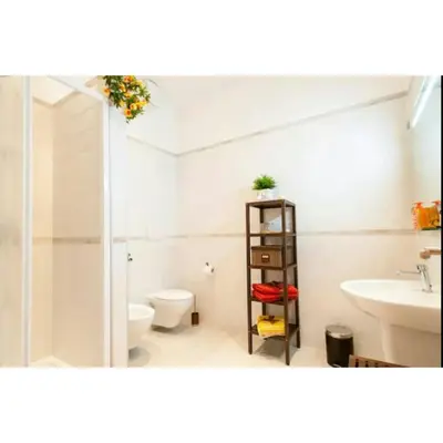 a bathroom with a toilet and a sink at Domus Ines Roma San pietro in Rome
